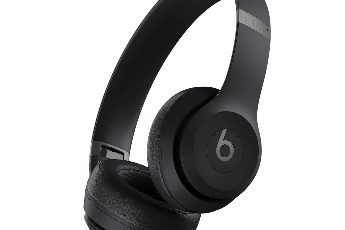 Beats wireless headphones on a table with a smartphone showing location tracking