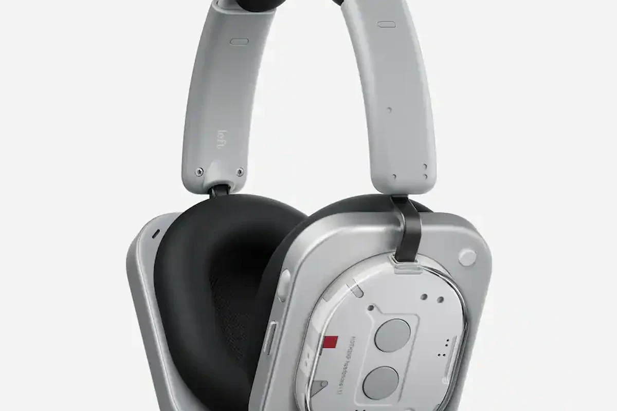 Wireless gaming headphones and Bluetooth transmitter setup for PS5 on a desk
