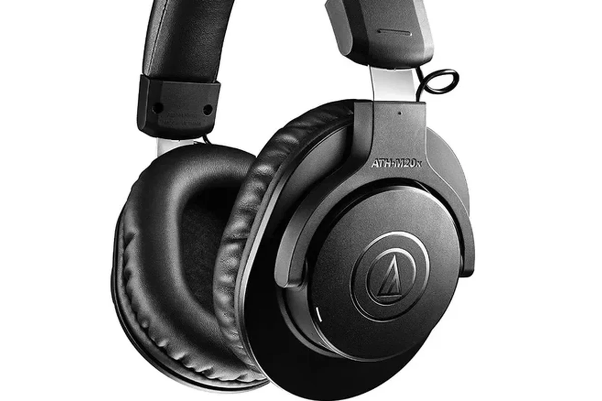 Traveler using Bluetooth headphones with a JetBlue seatback TV on an airplane