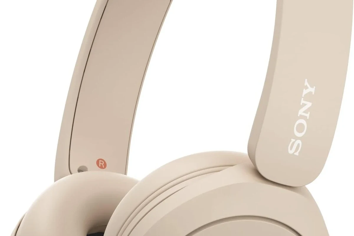 Person connecting wireless headphones to a smart TV with Bluetooth and transmitter options