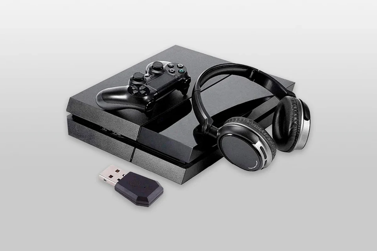 Bluetooth headphones connected to a PS4 controller and console setup for gaming audio