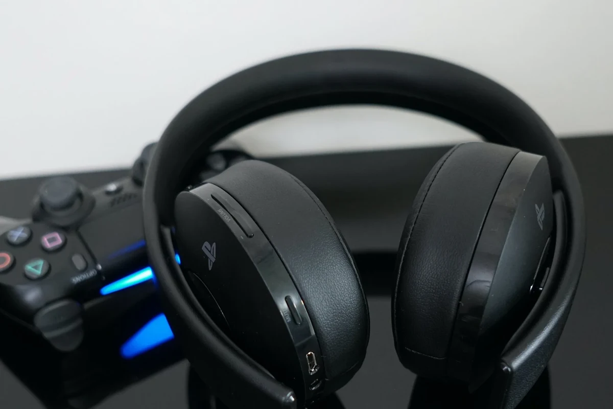Bluetooth headphones connected to a PS4 controller and gaming console setup