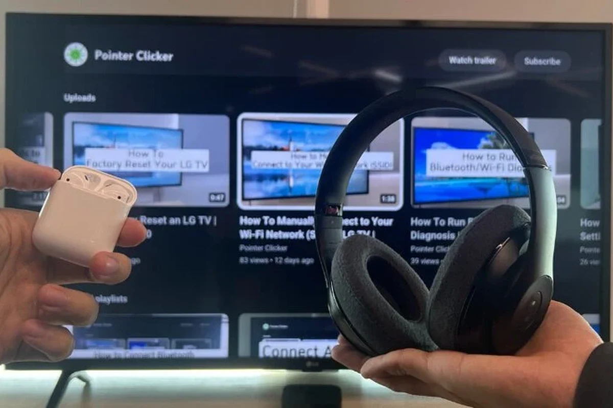 Person wearing wireless headphones while watching a TV in a living room