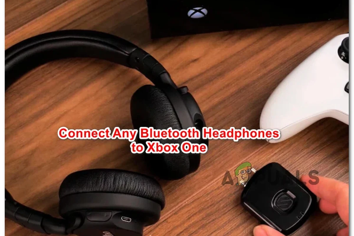 Xbox One console with Bluetooth headphones and wireless audio setup on a gaming desk