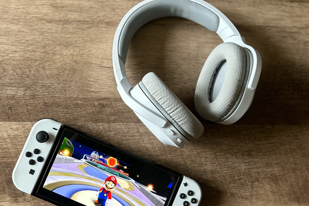 Nintendo Switch console with wired and Bluetooth headphones for gaming audio setup