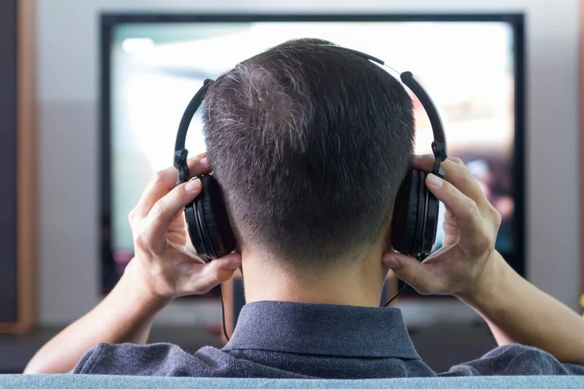Wireless headphones connected to an LG TV using an external audio transmitter setup