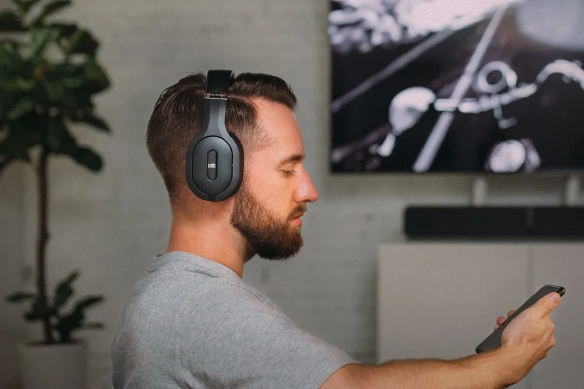 Wireless headphones paired to a TV in a modern living room setup