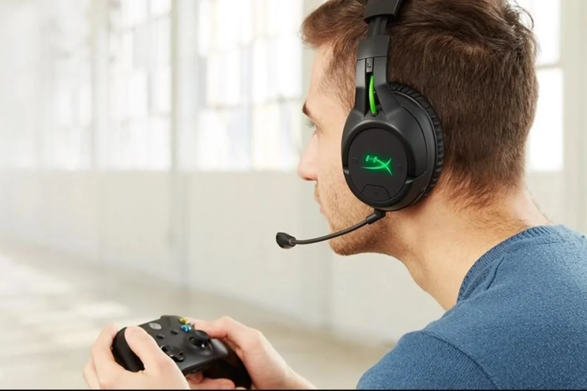 Wireless gaming headphones connected to an Xbox console with a controller nearby