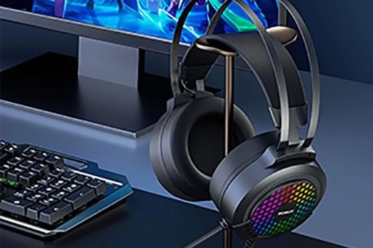 Wireless gaming headset connected to a PS5 console with controller on a desk