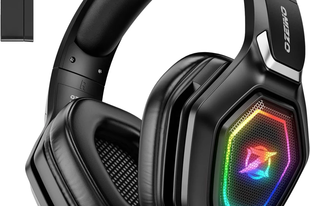 Wireless gaming headphones and Bluetooth transmitter setup for PS5 on a desk