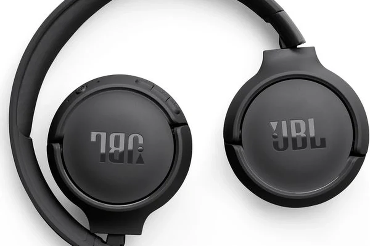 JBL wireless headphones and a Bluetooth tracker case on a desk