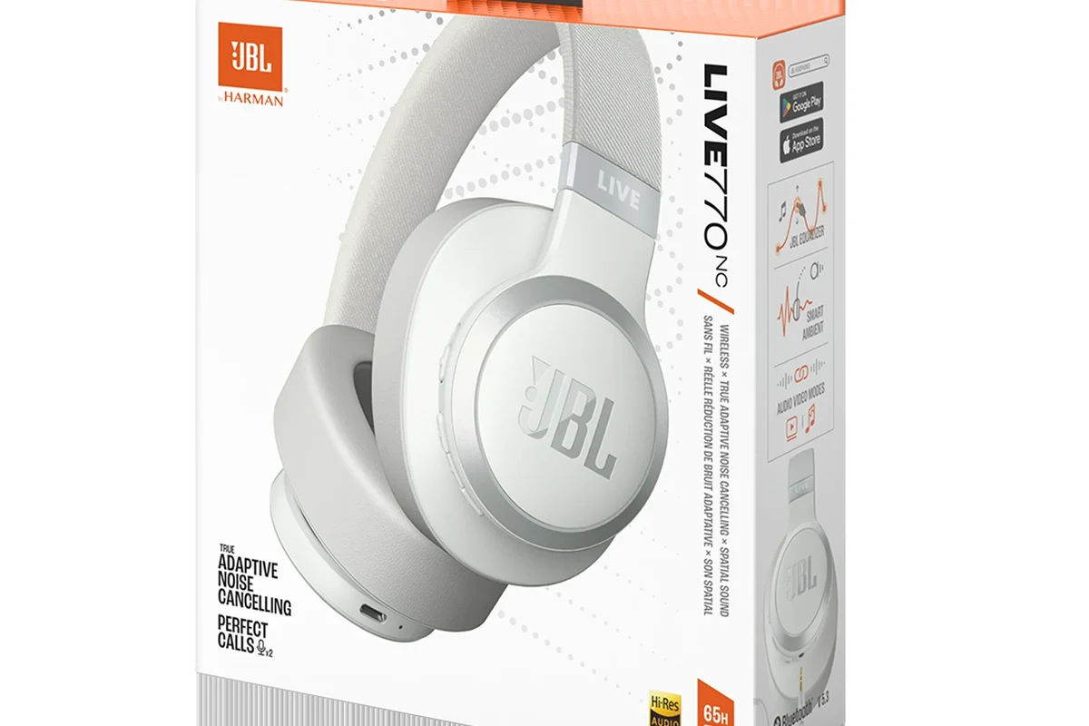 JBL wireless headphones and a Bluetooth tracker case on a desk
