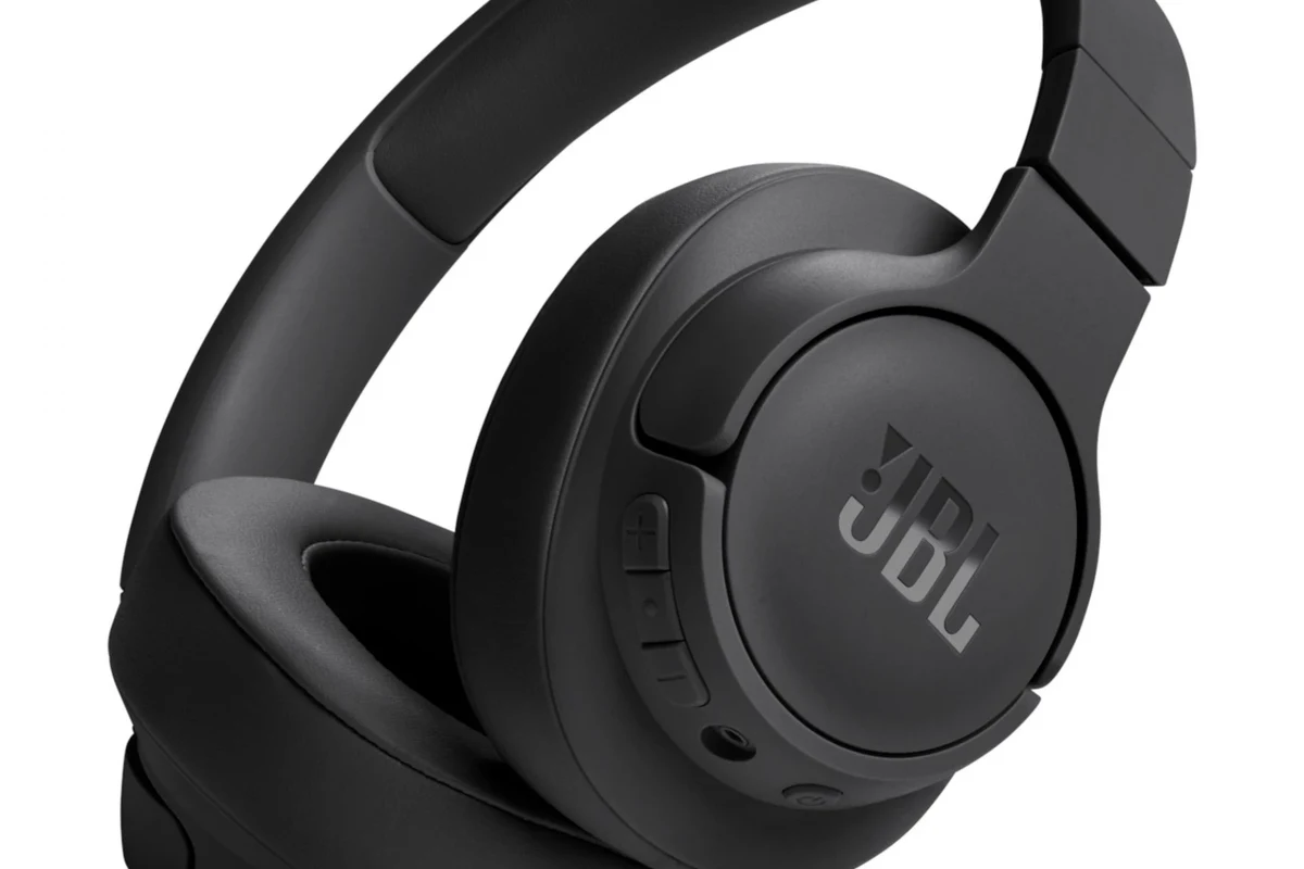 JBL headphones paired with an iPhone on a desk showing Bluetooth compatibility