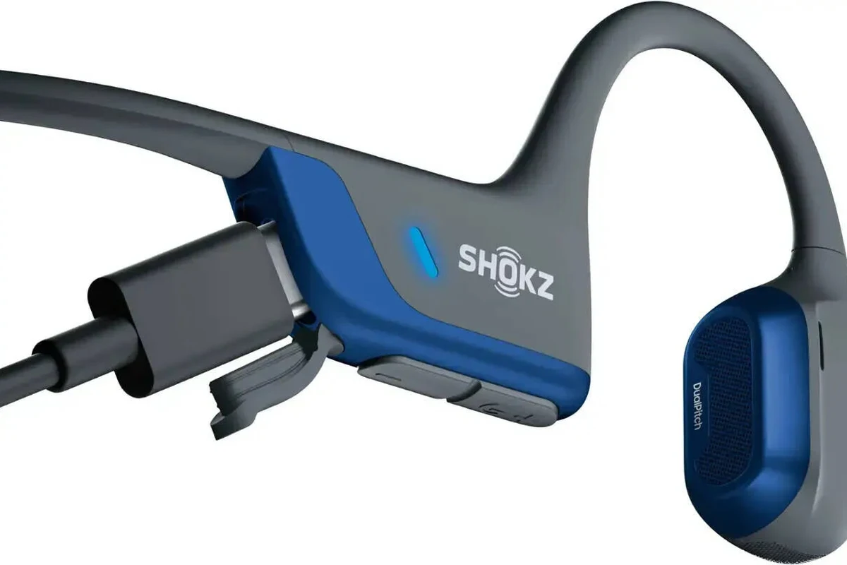 Shokz open-ear headphones on a running path showing battery life and daily use