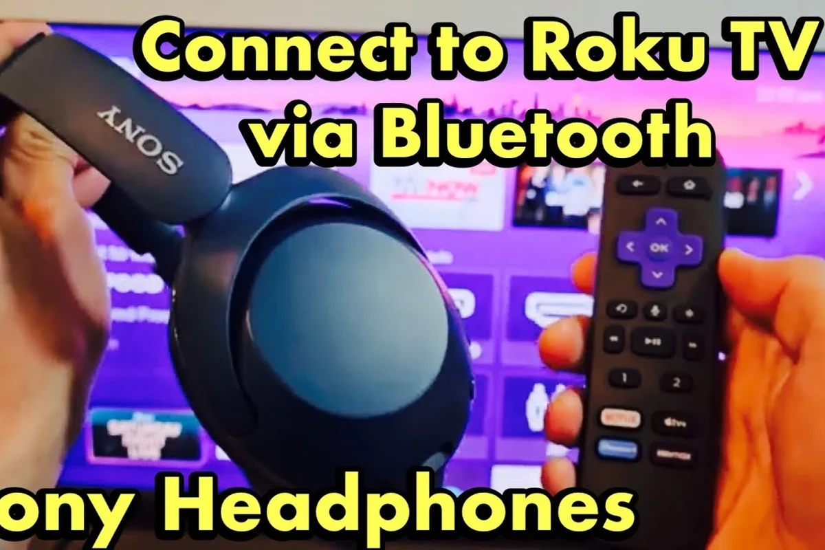 Person pairing Bluetooth headphones to a Roku TV for private listening in a living room