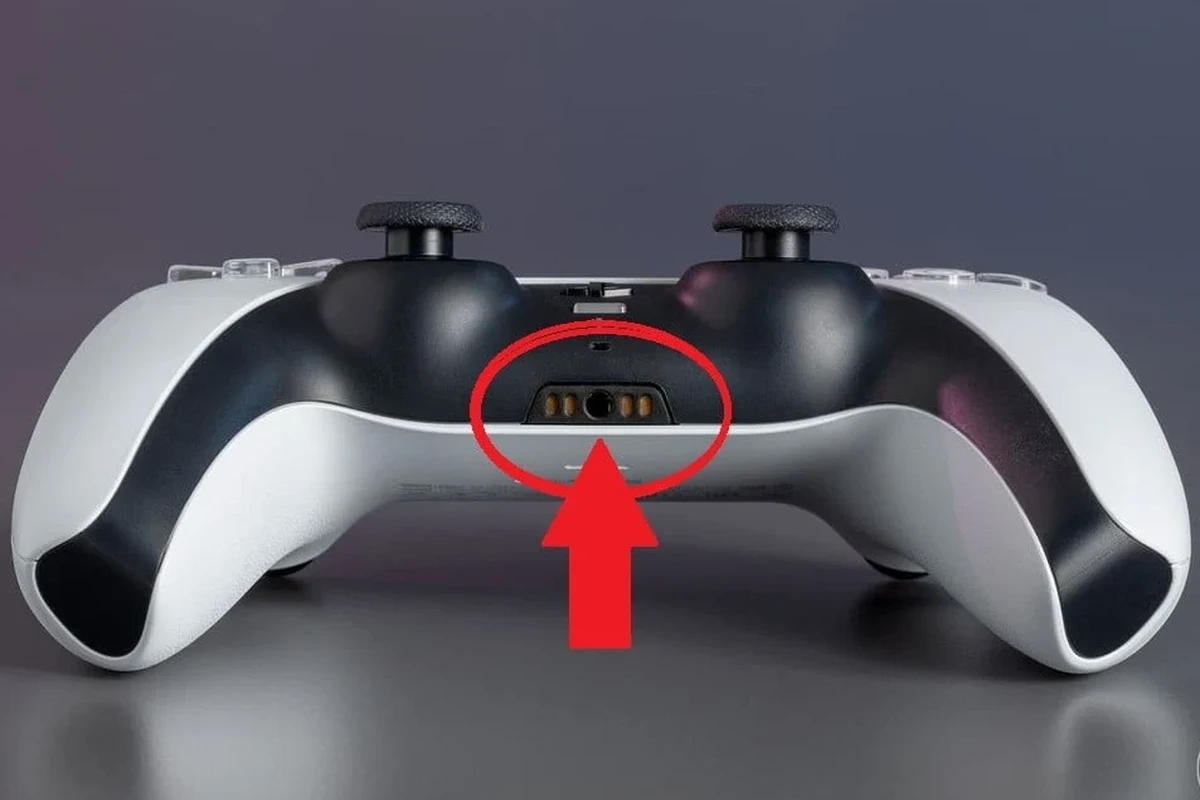 PS5 DualSense controller with wired headphones plugged into the 3.5mm audio jack