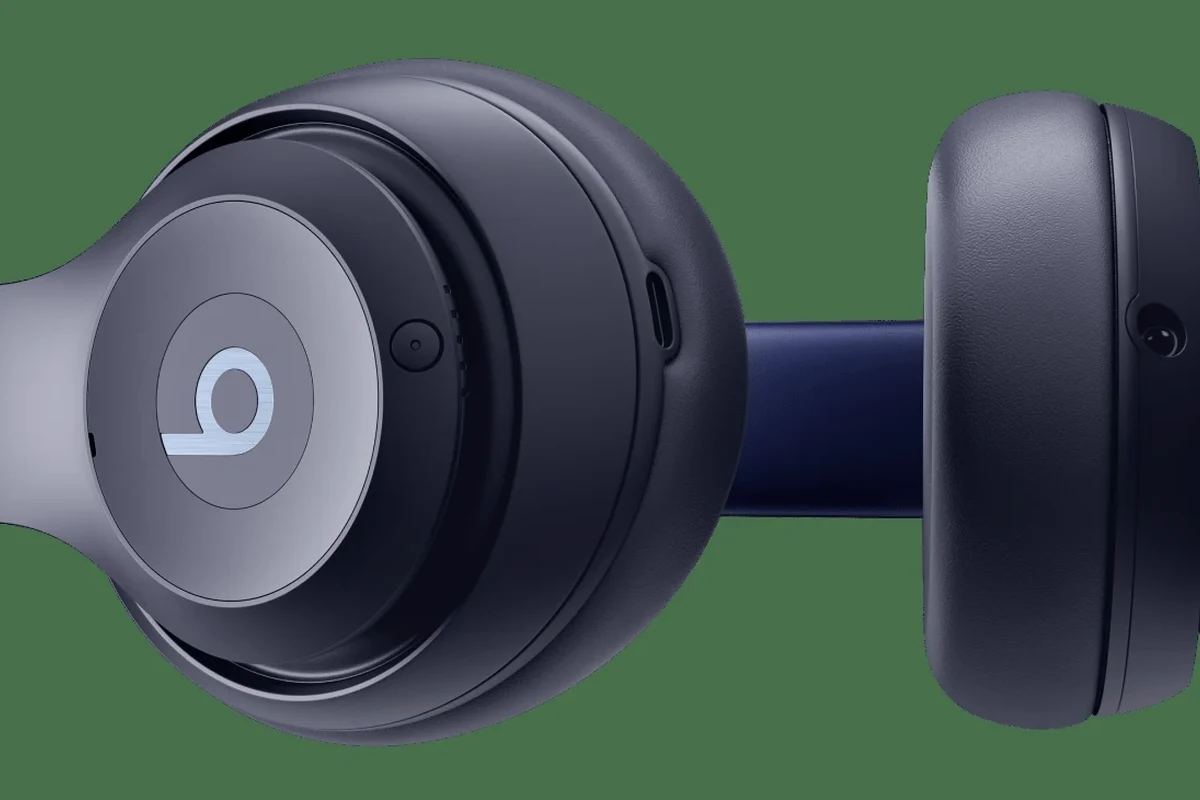 Person restarting Beats headphones while checking Bluetooth connection on a phone