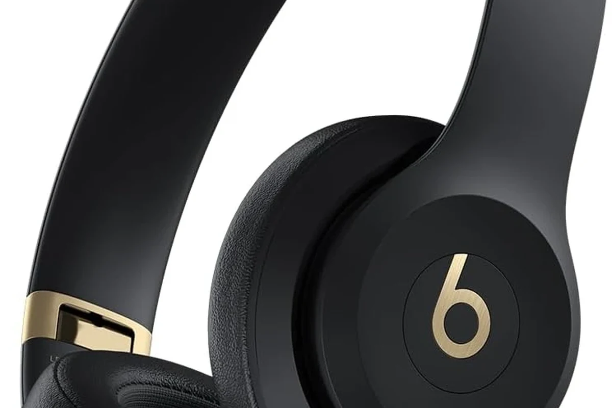 Beats headphones for sale with box, charging cable, and listing setup on a clean desk