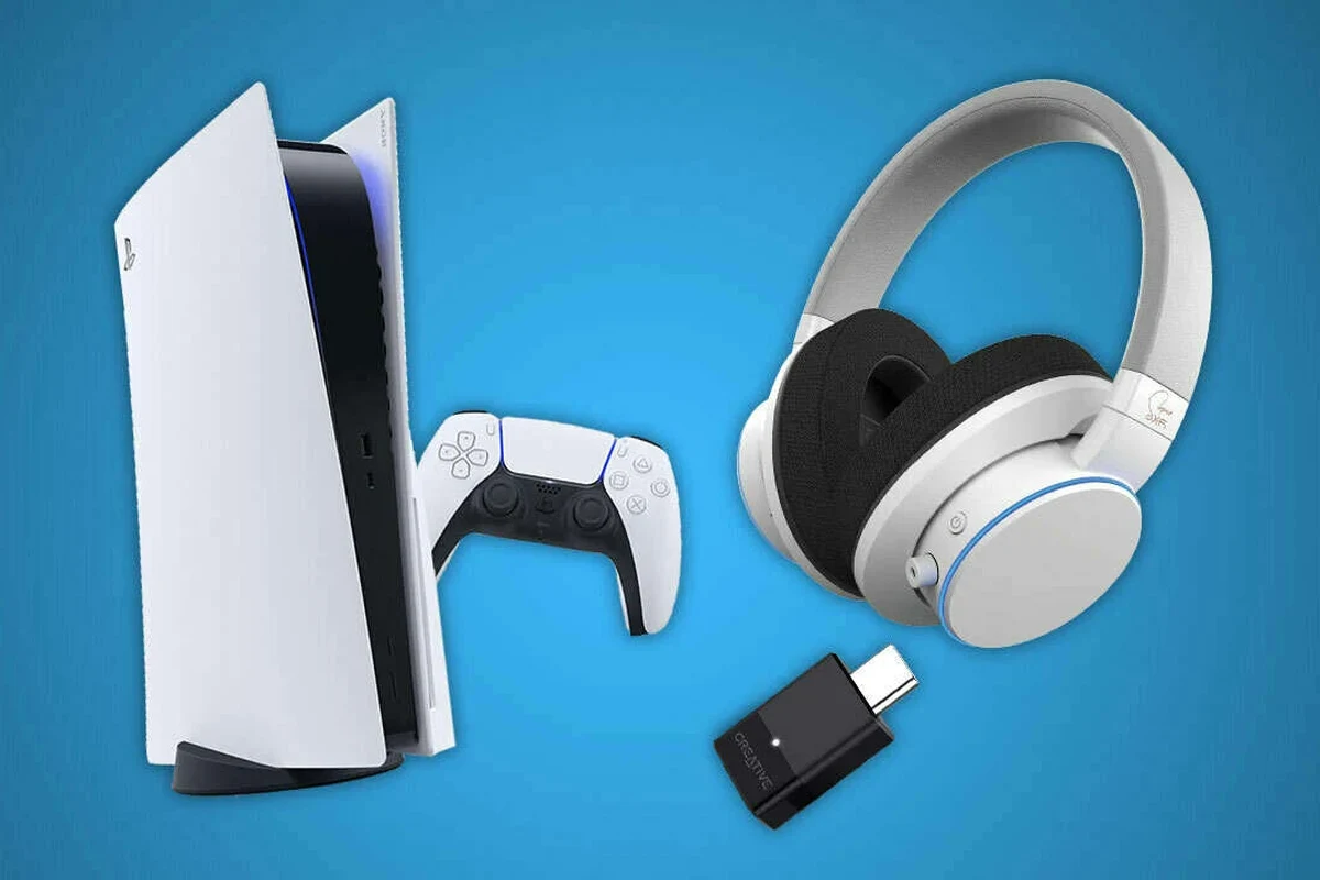 PS5 console with wireless gaming headphones and USB adapter on a desk