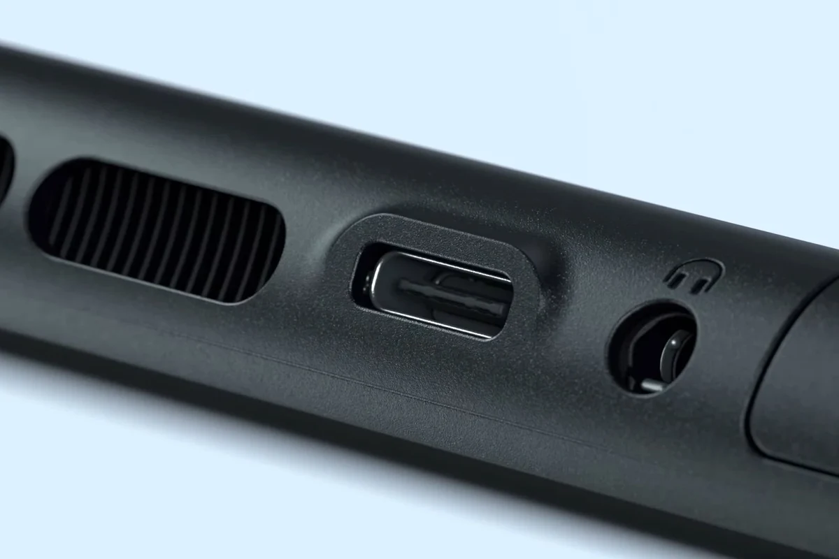 Nintendo Switch 2 handheld gaming console with wired headphones plugged into the 3.5mm audio jack