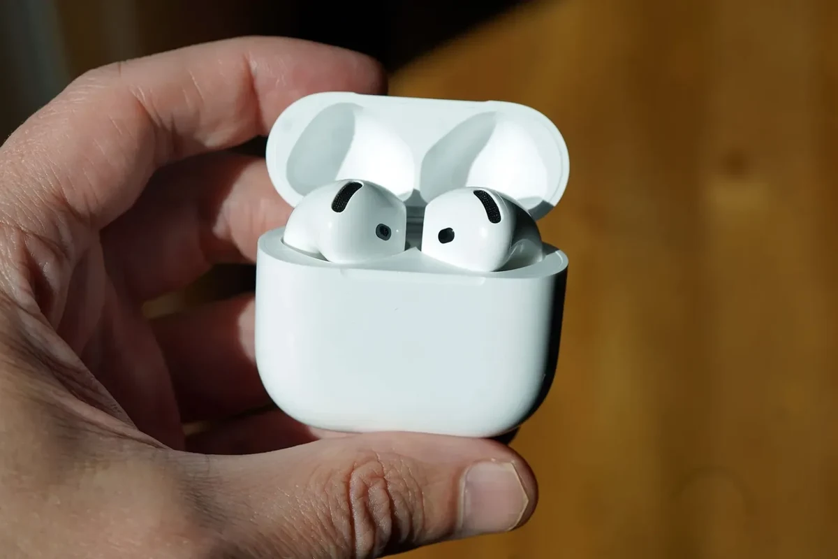 Apple headphones, including AirPods and Beats, shown with a charging case and Bluetooth device settings