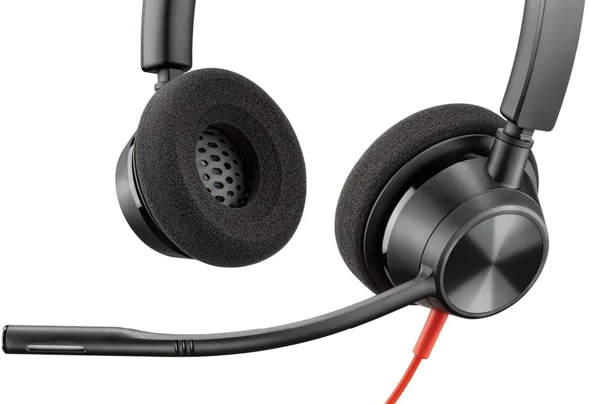 USB-C headphones connected to a MacBook on a desk with audio settings visible