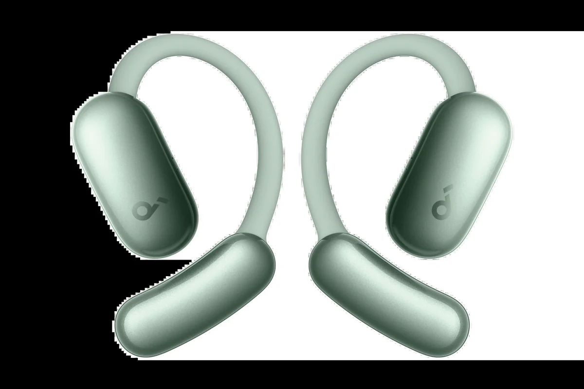 Person watching TV with over-ear headphones in a quiet living room at night