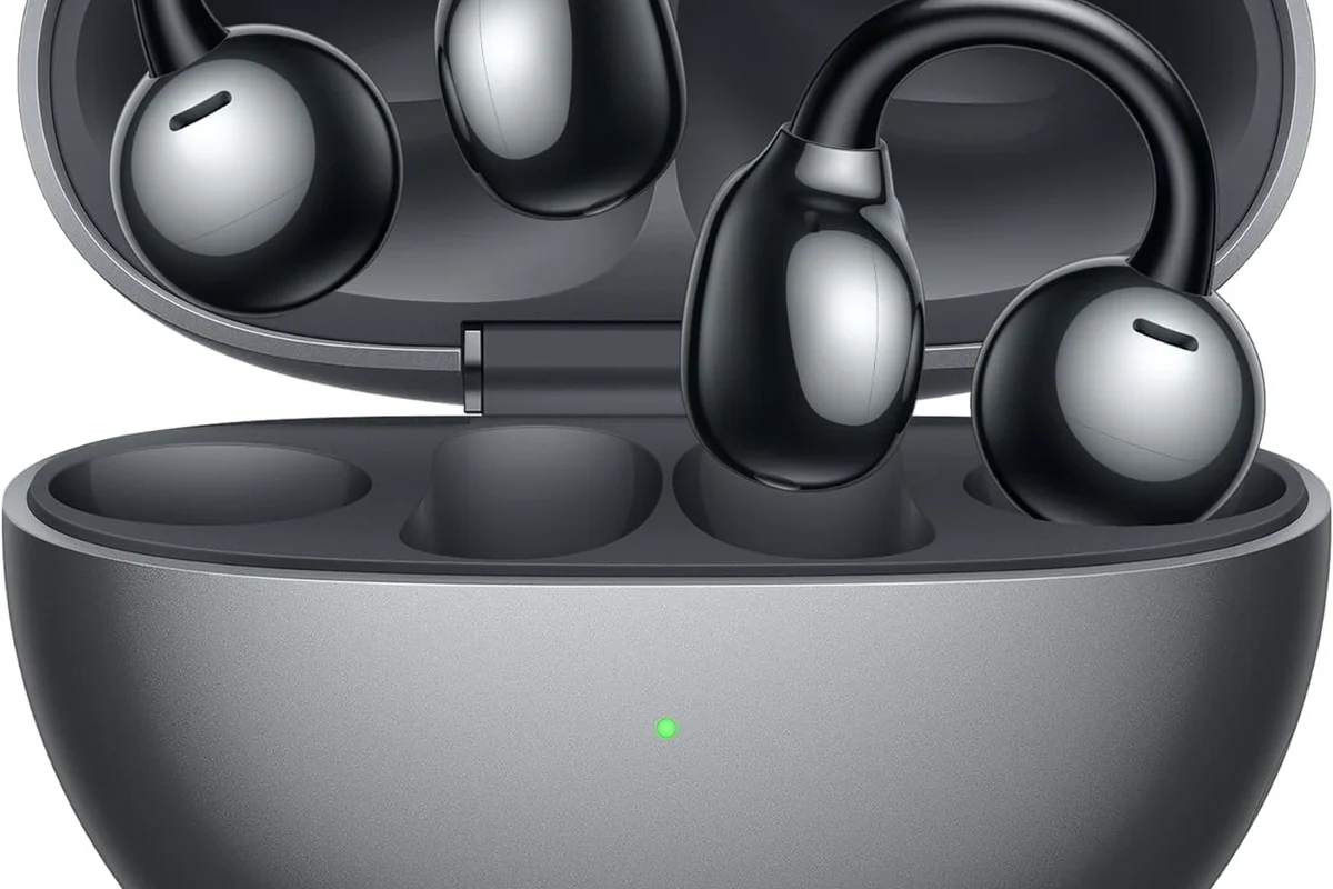Xbox One console with gaming headset and Bluetooth headphones on a desk