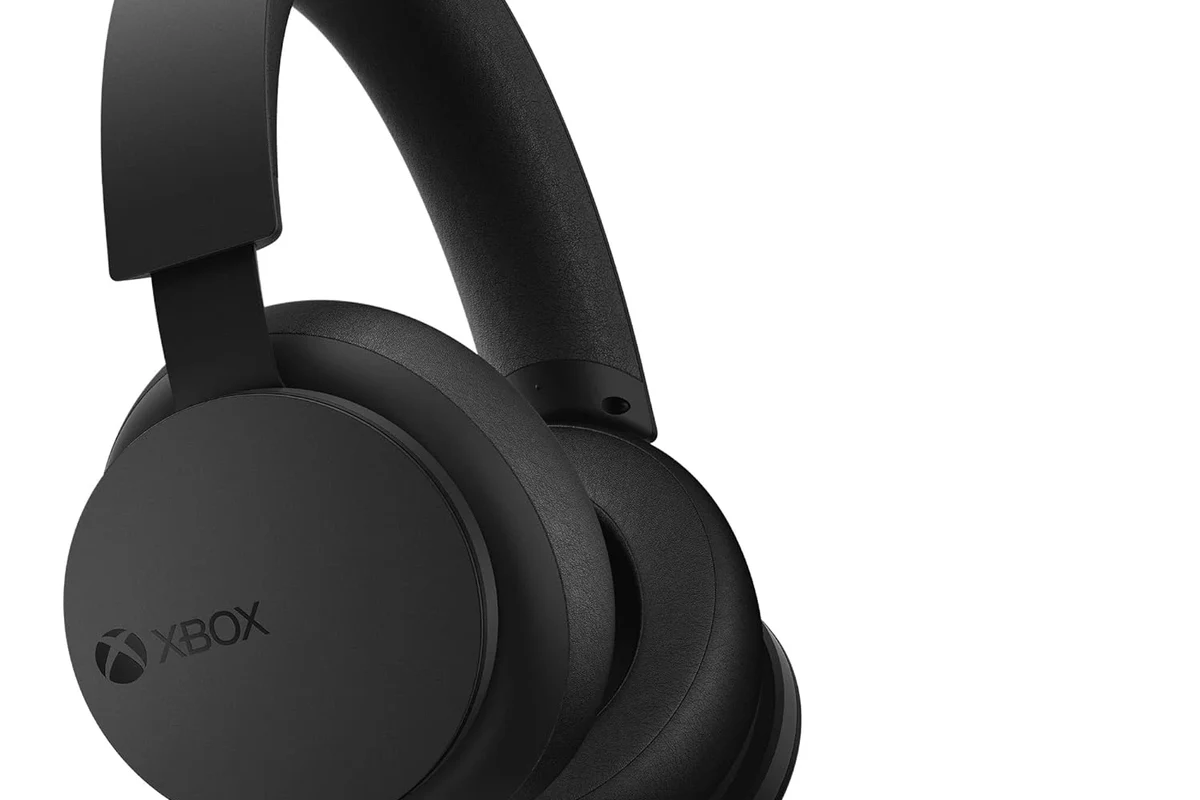 Xbox console with gaming headphones and wireless audio setup on a desk