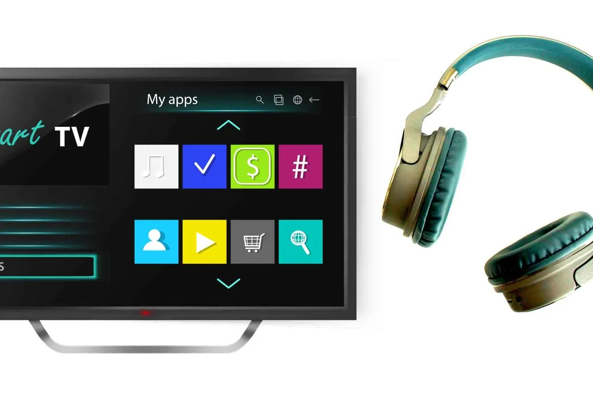 Person connecting Bluetooth headphones to a smart TV in a living room