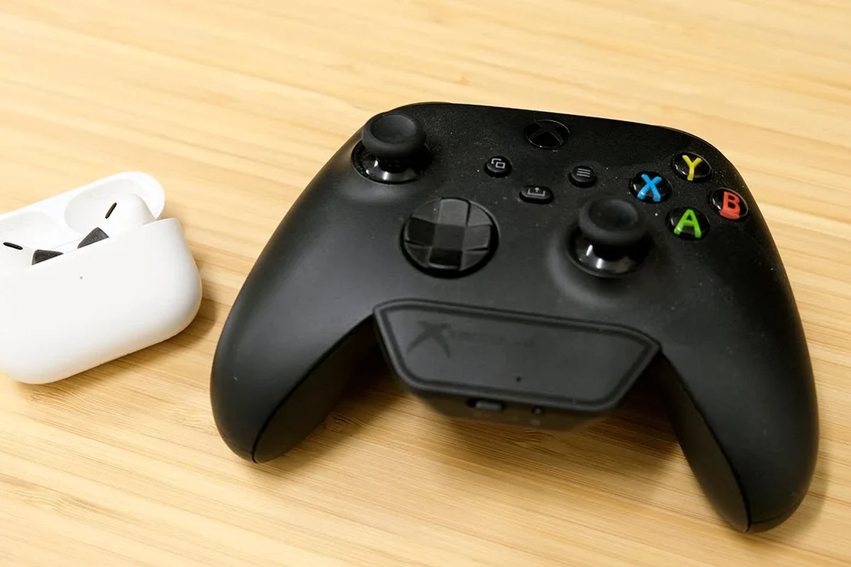 Xbox Series X with gaming headset and Bluetooth adapter on a desk