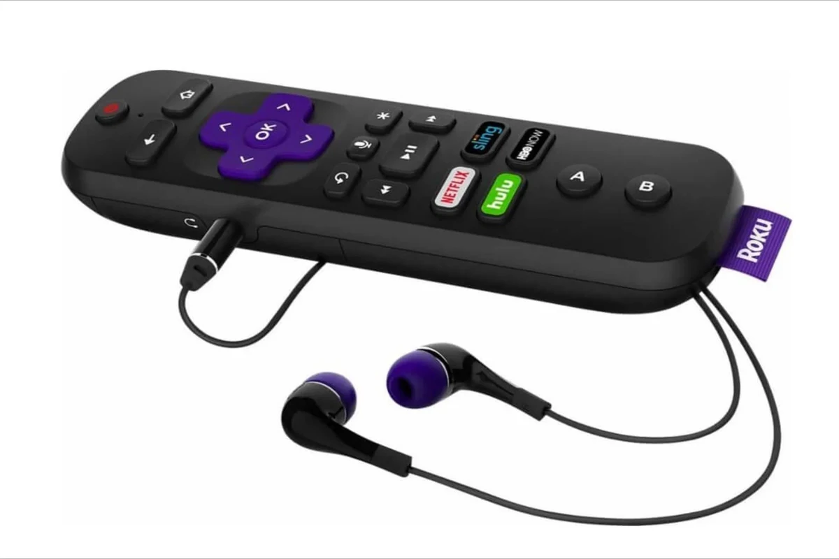 Person wearing headphones while watching Roku TV in a living room