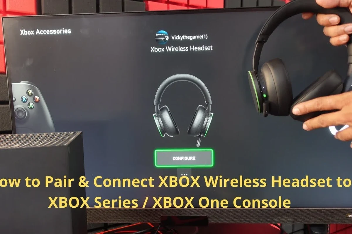 Wireless gaming headset connected to an Xbox console beside a TV in a living room