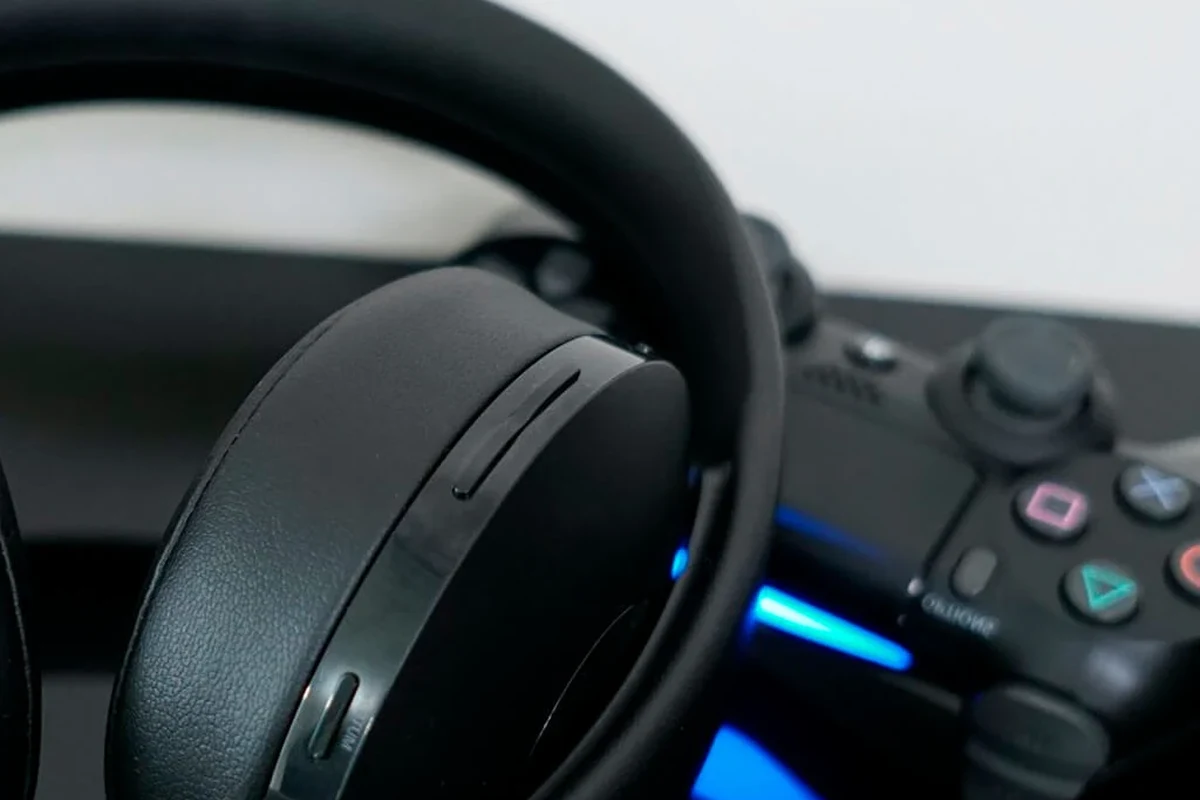 Gaming headset and Bluetooth transmitter connected to a PS4 console for wireless audio