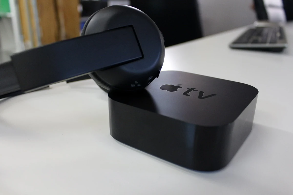 Person watching TV with Bluetooth headphones in a quiet living room
