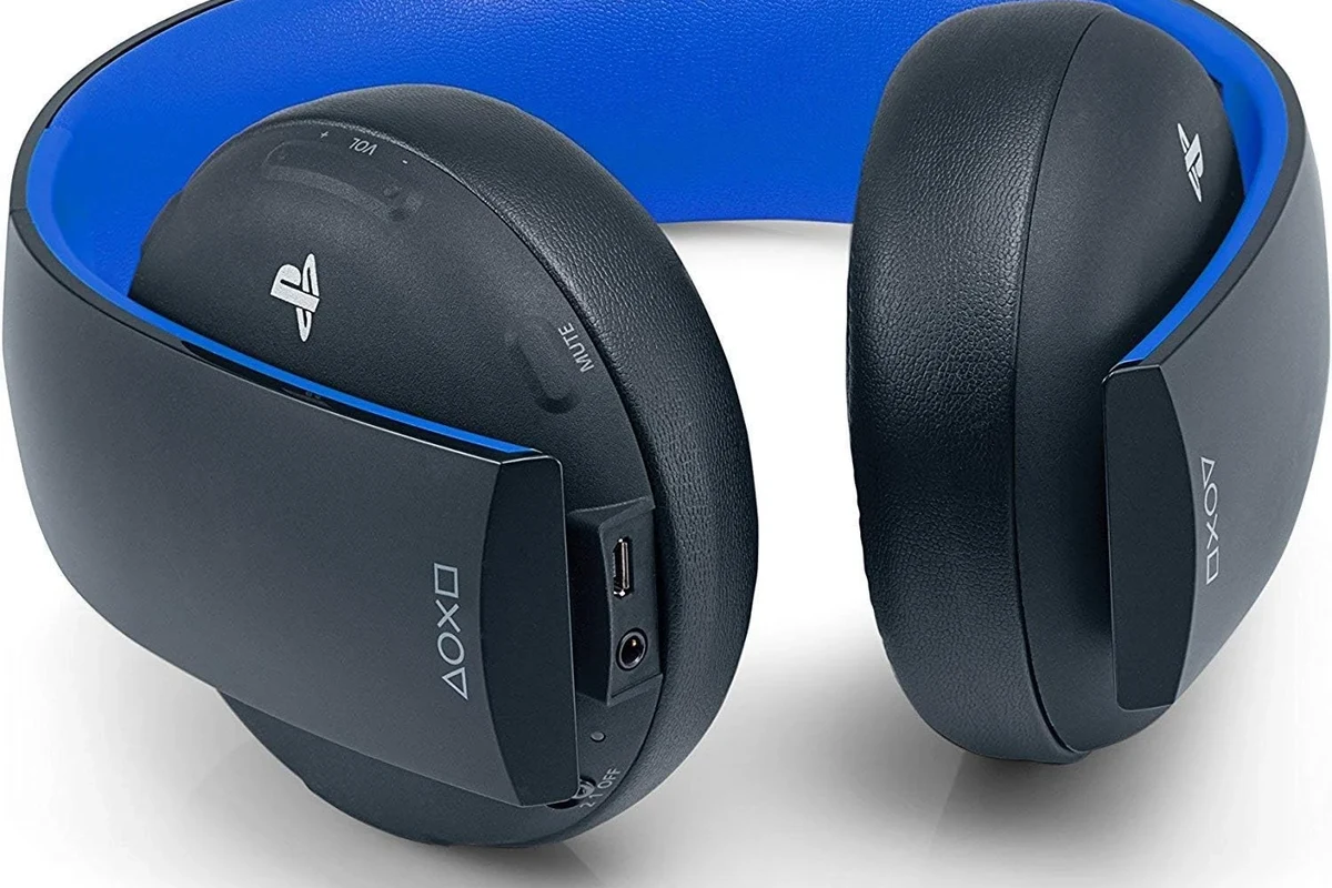 Gaming headset beside a PS4 controller on a clean desk setup
