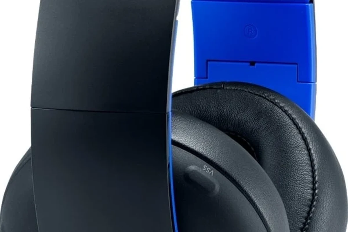 PS4 gaming headphones on a clean desk beside a controller and console setup