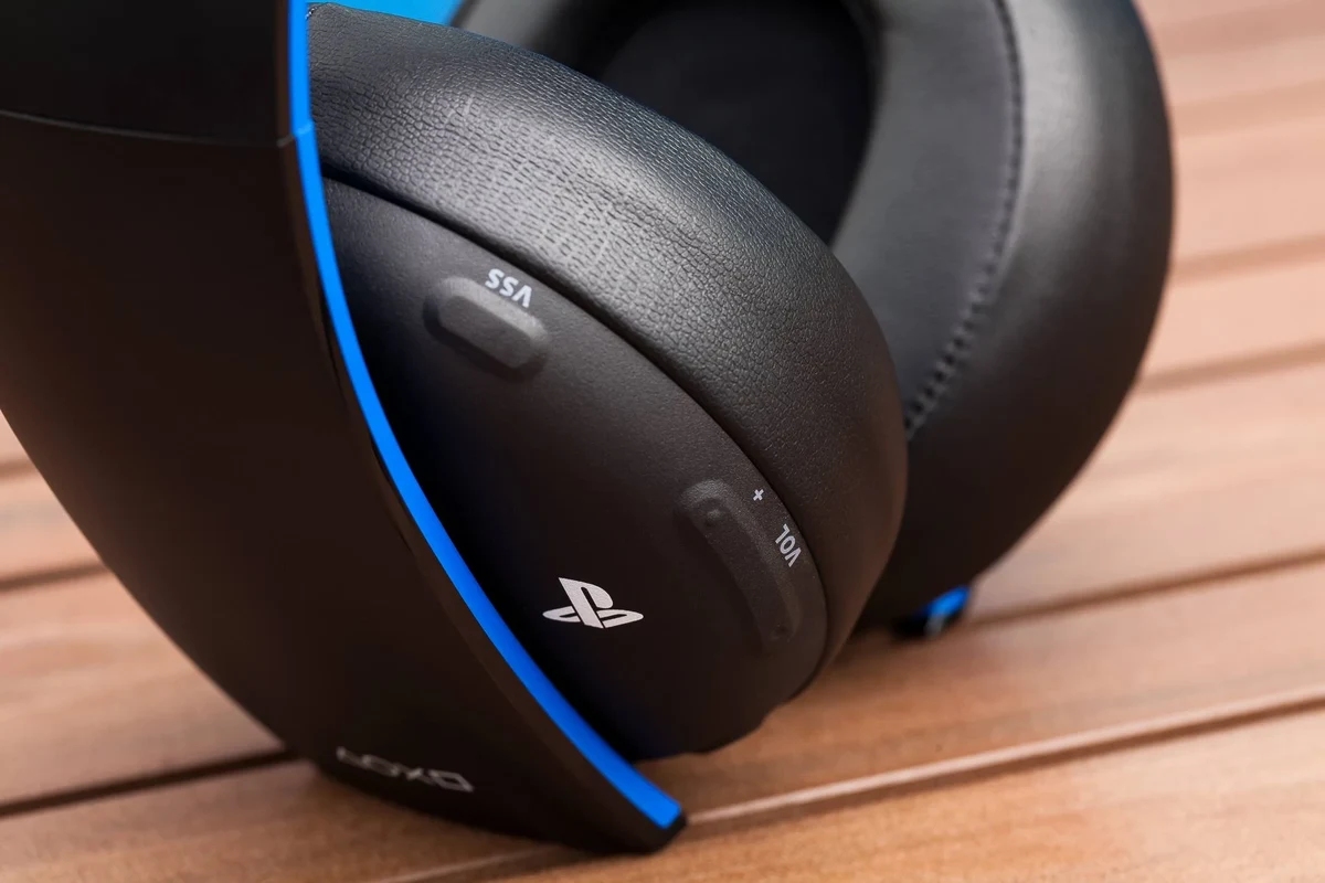 PS4 gaming headset on a clean desk setup beside a controller and console